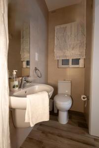 a bathroom with a white toilet and a sink at Four Seasons Apartment 9 in St. Paul's Bay