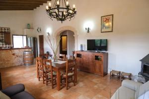 a living room with a dining room table and a television at Son Rossinyol by Rentallorca in Sineu