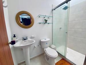 a bathroom with a toilet and a sink and a shower at La palma- casa amoblada Palma Mayorca in Sincelejo