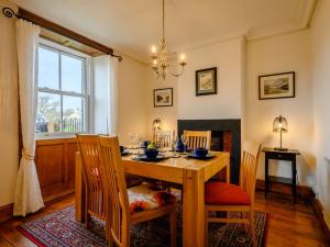 a dining room with a wooden table and chairs at 3 Bed in Ennerdale SZ392 in Ennerdale Bridge