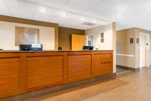 an empty lobby with a large wooden reception desk at Comfort Suites Wilmington near Downtown in Wilmington