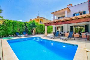 a swimming pool in front of a house at Can Caldero by Rentallorca in Llucmajor