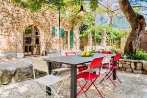 einen Tisch und Stühle auf einer Terrasse mit einem Baum in der Unterkunft Finca Can Busquera by Rentallorca in Sóller