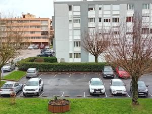 a parking lot with cars parked in front of a building at Monte Cristo in Metz