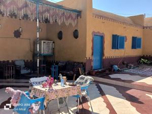 a table and chairs in front of a building at Arafa Nubian Guest house in Aswan