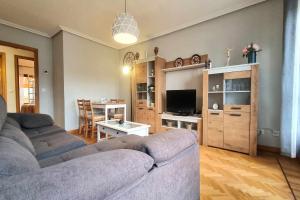 a living room with a couch and a table at Apartamento Saavedra in Posada de Llanes