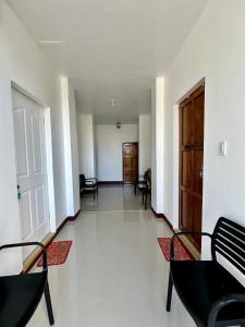 an empty hallway with chairs and a door at Marz inn Moalboal in Moalboal