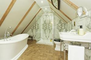 a bathroom with a tub and a sink and a shower at Old Town House by Ezestays in Margate +37 photos