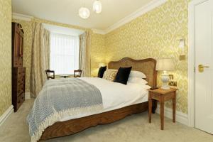 a bedroom with a large bed and a window at Old Town House by Ezestays in Margate
