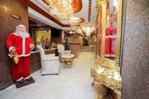 a santa claus standing in a room in a store at Cairo City Center Dreamers Hotel & Suites in Cairo