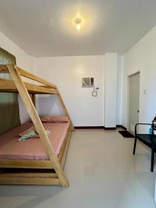 a room with two bunk beds in a room at Marz inn Moalboal in Moalboal