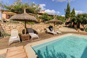 a swimming pool with chairs and umbrellas next to a house at Son Cladera Bosch by Rentallorca in Manacor