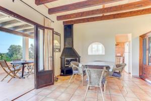 a dining room with a table and a fireplace at S'Albufereta by Rentallorca in Alcudia