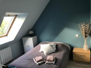 a bedroom with a bed with two towels on it at gîte de la scierie in Saint-Gâtien-des-Bois