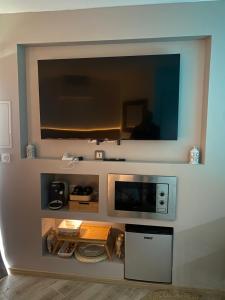 a kitchen with a microwave on a wall at Côté spa in Saint-Victoret