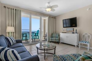 a living room with a couch and a tv at Majestic Sun 806B in Destin