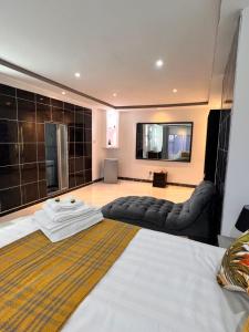 Habitación de hotel con cama y sofá en immaculate 5 bedroomed house en Bulawayo