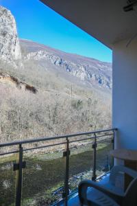 a room with a balcony with a view of a mountain at Apartments Murdzoski in Struga +26 photos