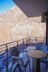a balcony with chairs and a table and a mountain at Apartments Murdzoski in Struga