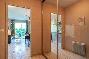 a room with a glass door leading to a living room at Le Cabellou - Appt avec piscine commune in Concarneau +6 photos