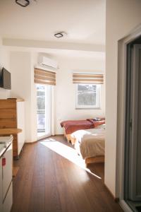 two beds in a room with two windows at Apartments Murdzoski in Struga