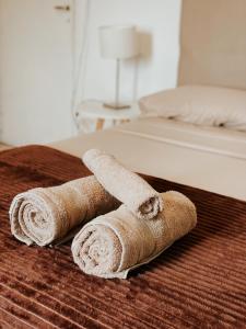un par de toallas enrolladas sentadas en una cama en Departamento Nórdico en Posadas