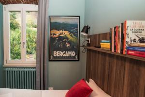 a bedroom with a poster on the wall and a book shelf at AL NIDO LEGAMI charme e relax in Bergamo