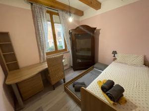 a bedroom with a bed and a desk and a window at Villa Noa jacuzzi & sauna in Izola
