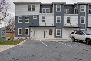 a white truck parked in a parking lot in front of a building at Modern Townhome, 10min to Downtown! 8min to Grand Ole Opry! Sleeps 8! in Nashville