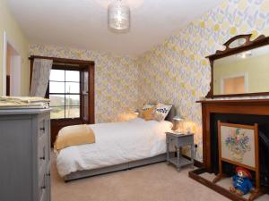 a bedroom with a bed and a mirror at 5 bed in Chirnside 77337 in Duns