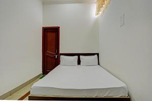 a bedroom with a white bed in a room at OYO New dream in Nārnaul