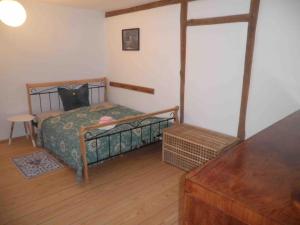 a bedroom with a bed and a wooden floor at Erholen im Kranichhof, Garten, Sauna - Nähe Heide in Mockrehna