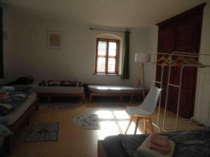 a living room with a couch and a chair at Erholen im Kranichhof, Garten, Sauna - Nähe Heide in Mockrehna