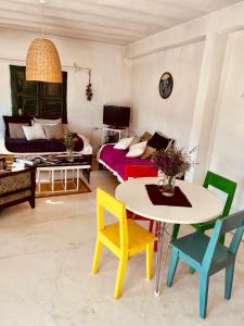 a living room with a table and chairs and a couch at Casa Buika in Tilcara