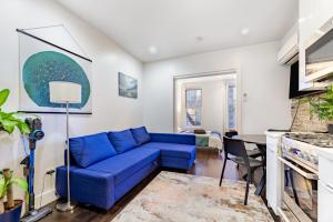a living room with a blue couch at Explore Hudson Yards at Aesthetic Prime 2BD Apartmnet in New York