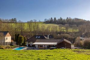 a house with a pool in the middle of a field at Nature Retreat Pool, Hot Tub, Sauna, Hiking-Caves in Hohenfels-Essingen