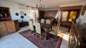 a living room with a wooden table and chairs at Villa dans son jus avec grande piscine privée in Saint-Aygulf +2 photos