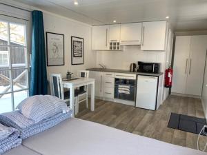 a kitchen with a bed and a table in a room at Ursand Resort & Camping in Vänersborg