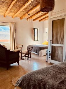 a bedroom with two beds and a window at Casa Buika in Tilcara