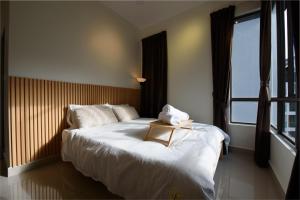 a bedroom with a large white bed with a tray on it at Myuko Homestay (2-7 pax) 10min to BOH in Brinchang