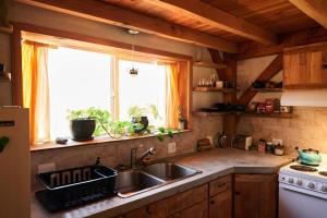 a kitchen with a sink and a window at Timber frame guesthouse in NE Portland in Portland