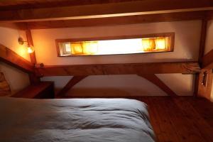 a small room with a bed and a window at Timber frame guesthouse in NE Portland in Portland