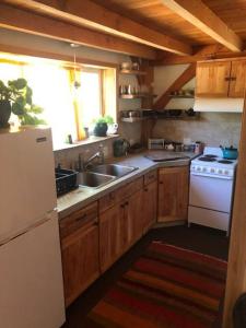 a kitchen with a sink and a stove at Timber frame guesthouse in NE Portland in Portland