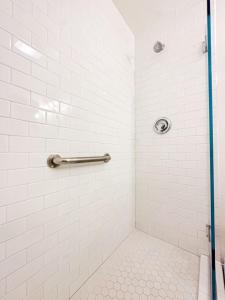 a bathroom with a shower with white tiles at 1 BR exceptional house PCHL-TOP in Topanga