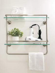 a glass shelf in a bathroom with towels at 1 BR exceptional house PCHL-TOP in Topanga