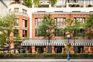 a large brick building with awning in front of it at The Hazelton Hotel in Toronto