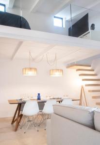 a dining room with a table and a staircase at YourHouse Iris House in Colonia de Sant Pere