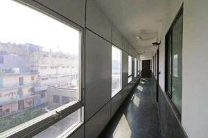 an empty hallway with windows in a building at HOTEL AEROPATH INN in New Delhi