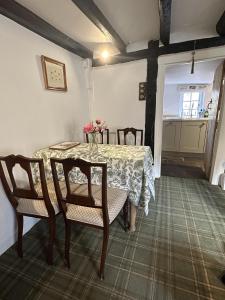 a dining room with a table and chairs and a window at Eglantine in Crondall