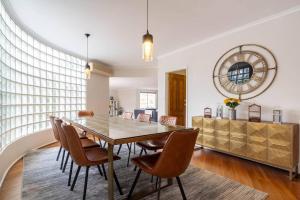 a dining room with a table and chairs at 'The Moondah Manor' A Poolside Family Retreat in Melbourne